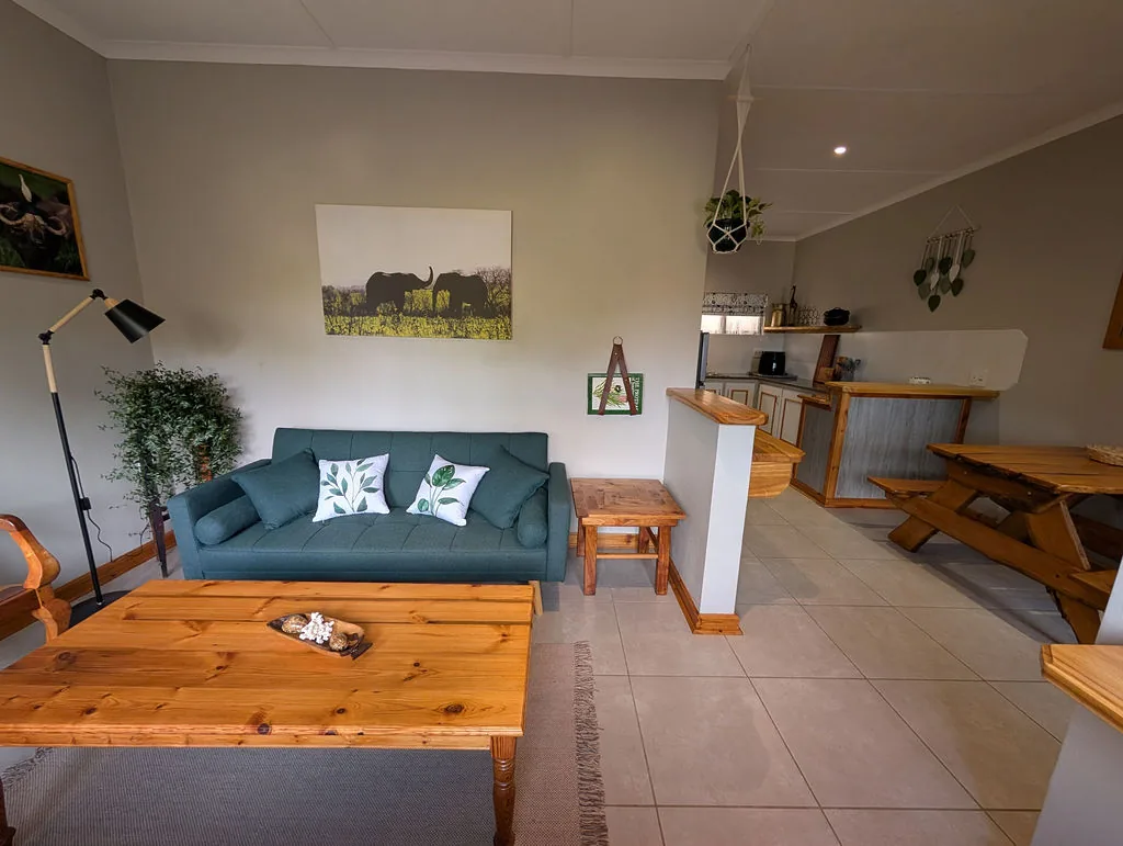 Lounge and kitchen connected by the open-plan living space at The Wood Haven