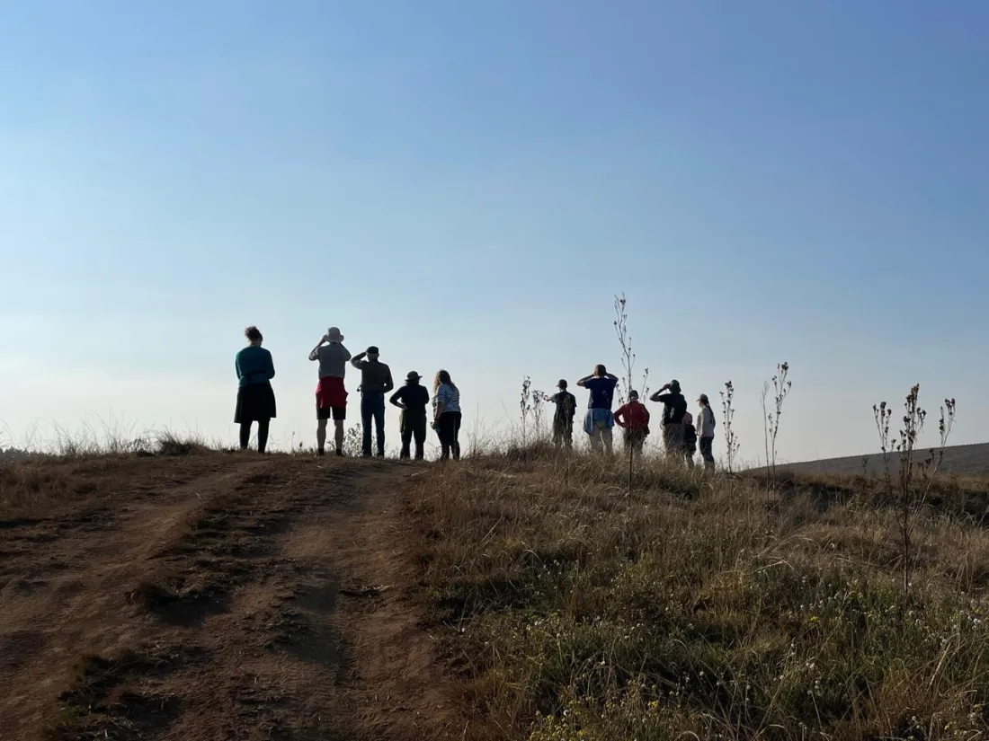 A birding group gathered at an open viewpoint near Hermannsburg
