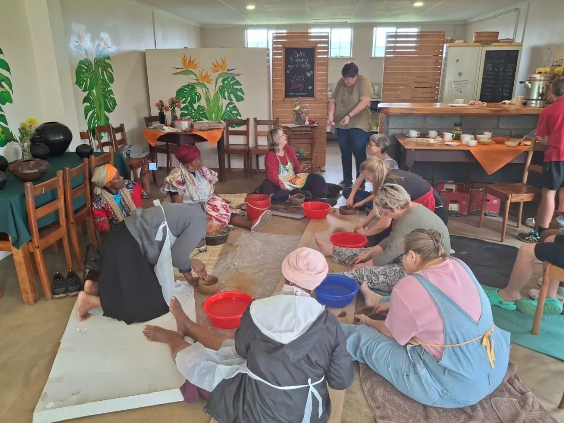 Participants learning traditional hand-built pottery at the Missionshaus Museum workshop
