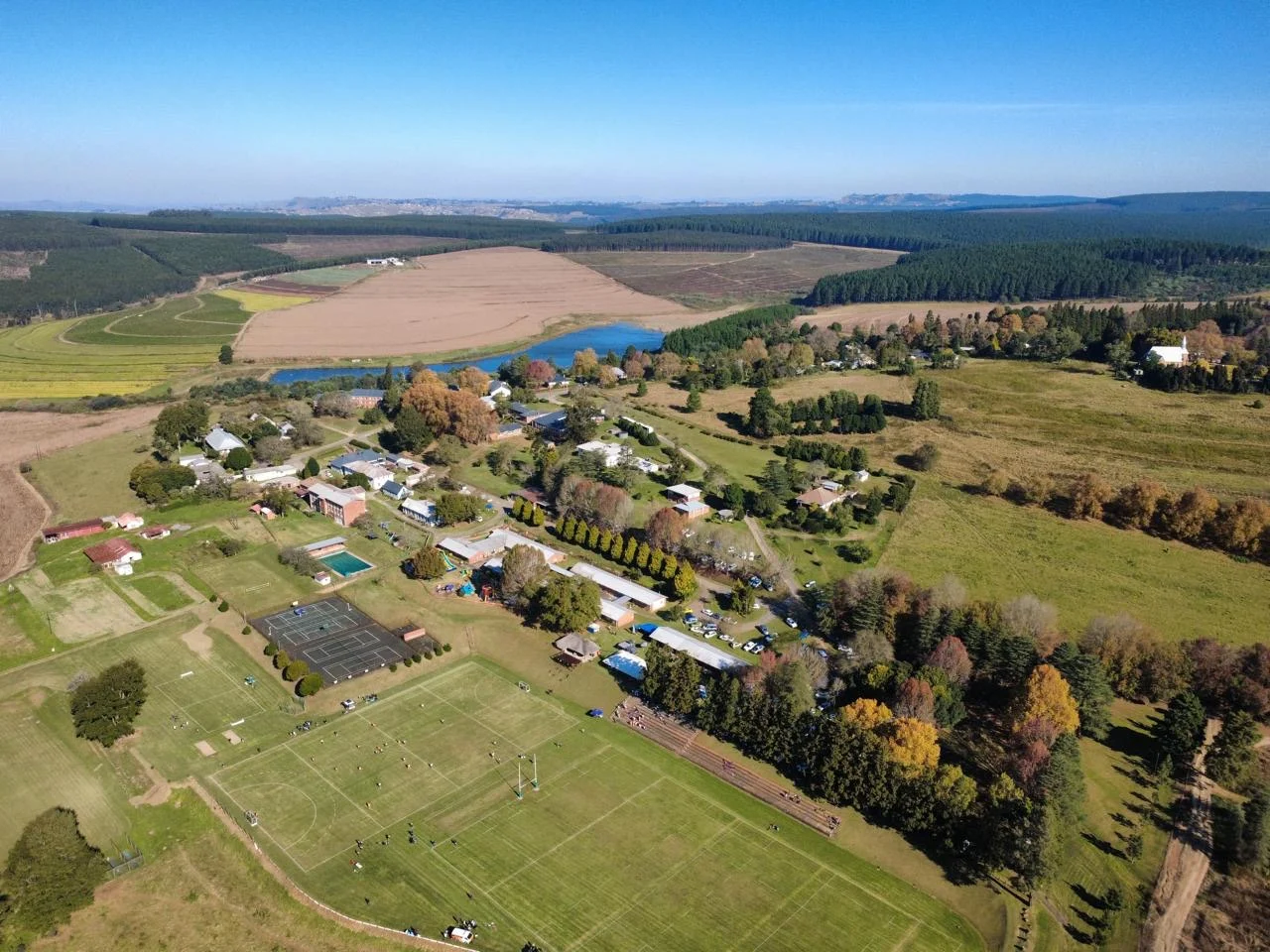 An aerial view of Hermannsburg Village, its playing fields, homes, water and surrounding farmland